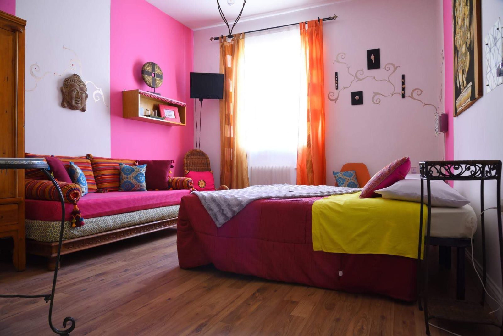 a room with pink walls and a bed